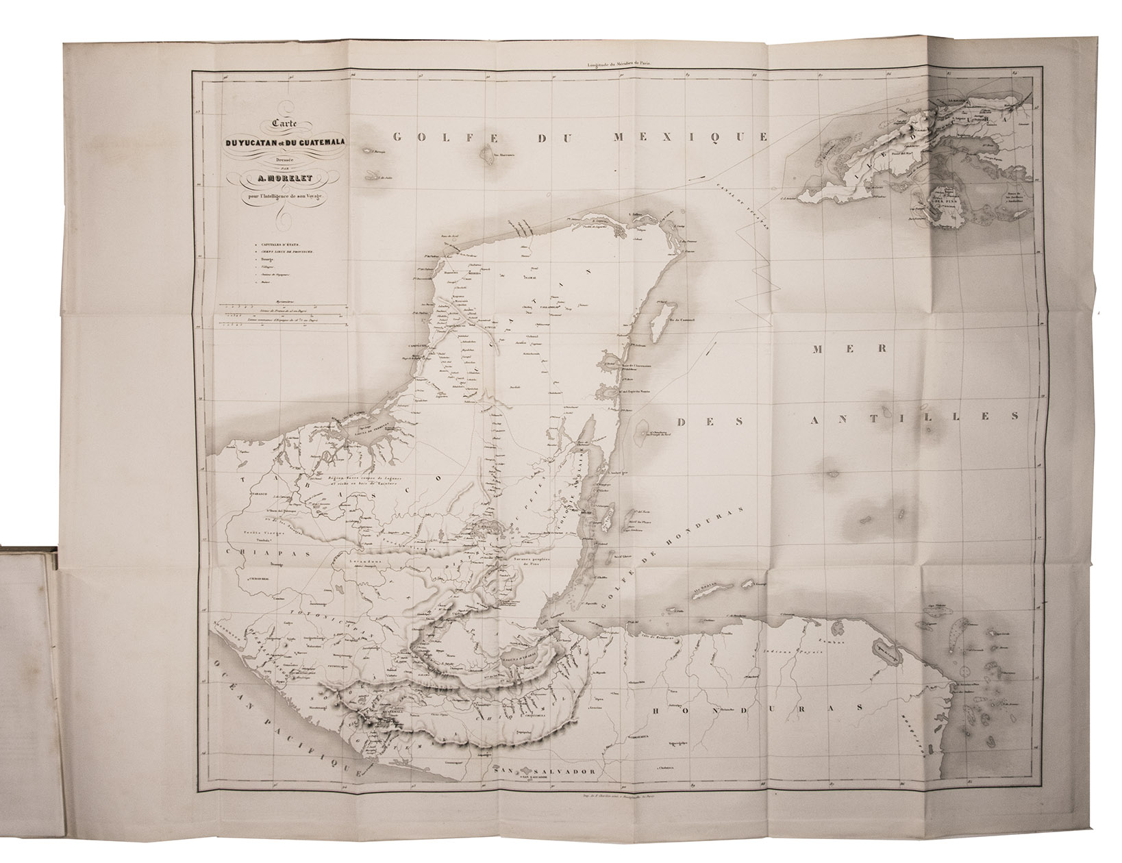 MORELET, Arthur. - Voyage dans l'Amrique centrale, l'le de Cuba et le Yucatan.Paris, Gide & J. Baudry, 1857. 2 volumes. 8vo. With 2 pages of letterpress music, a folding lithographed map of Yucatan, Guatemala and Cuba, and 22 wood-engraved illustrations, after drawings by the author, heading each chapter. Original publisher's printed paper wrappers, preserved in modern chemises and slipcase.