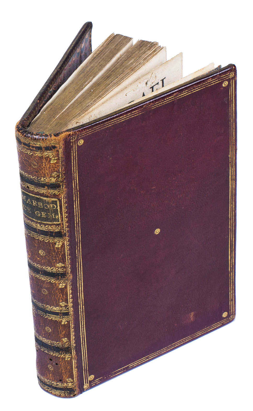 MARBODE (MARBODIUS) of Rennes. - De gemmarum lapidumq[ue] pretiosorum formis, naturis, atq[ue] viribus eruditu[m] cu[m] primis opusculu[m], ... scholiis q[uo]q[ue] illustratu[m] p[er] Alardu[m] Aemstelredamu[m].Cologne, Hero Alopecius [Fuchs], 1539. 8vo. With a woodcut illustration on the title-page, representing a Jewish priest behind a board with the names of 12 stones which represent the 12 tribes of Israel. 17th-century gold-tooled red morocco, richly gold-tooled spinel, gold-tooled fillets and small cornerpieces on both boards, gold-tooled board edges and turn-ins.