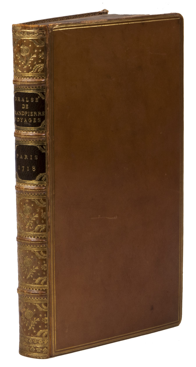 DRALS DE GRANDPIERRE. - Relation de divers voyages faits dans l'Afrique, dans l'Amrique, & aux Indes Occidentales. La description du Royaume de Juda, & quelques particularitez touchant la vie du roy reignant. La relation d'une isle nouvellement habite dans le dtroit de Malaca en Asie, & l'histoire de deux princes de Golconde.Paris, Claude Jombert, 1718. 12mo. With some woodcut head- and tailpieces. Contemporary gold-tooled polished calf, spine richly decorated with floral ornaments in compartments and with dark brown morocco labels lettered in gold, triple filets on boards, gold-tooled turn-ins, gilt edges.