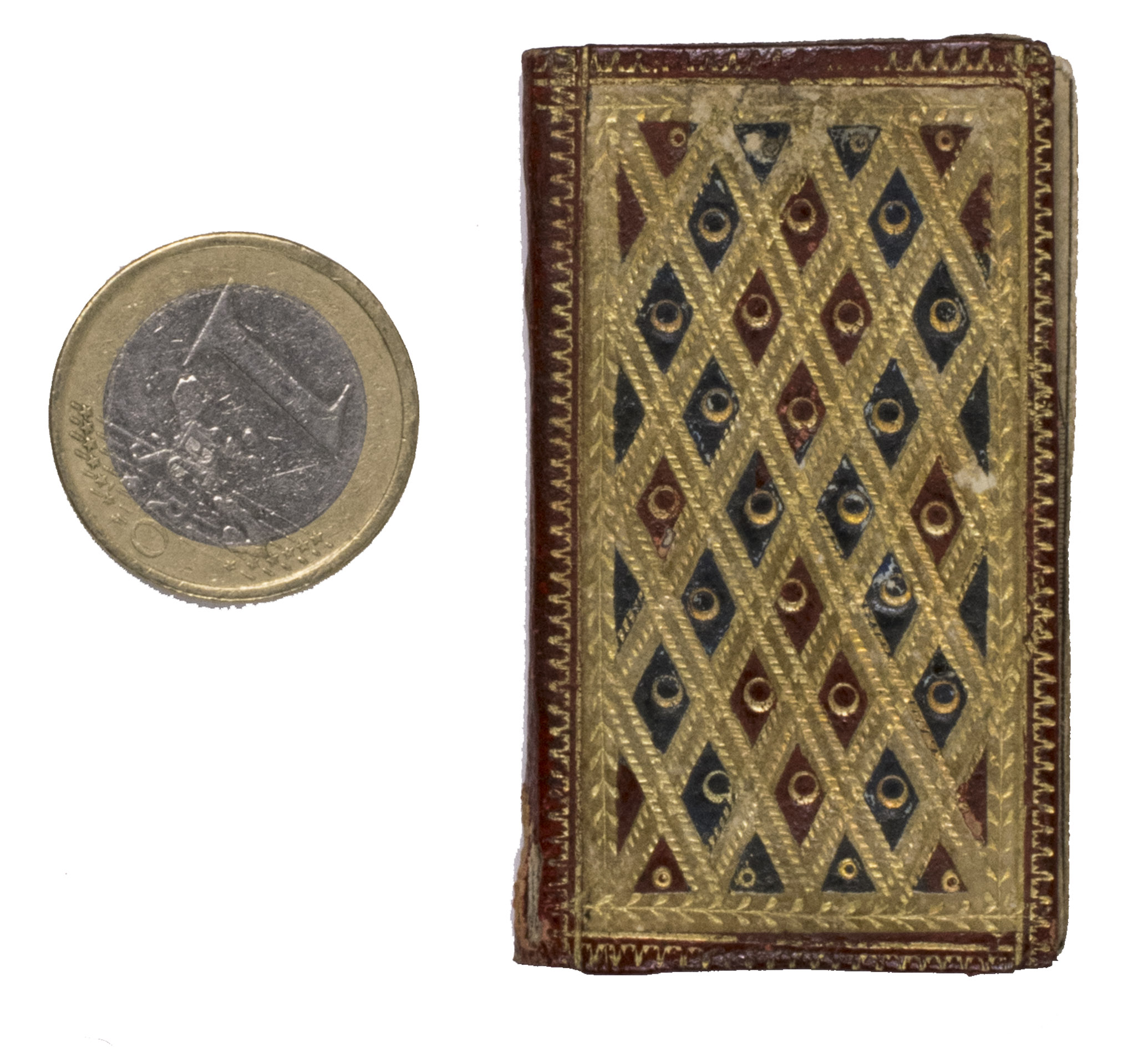 [MINIATURE BOOK - ALMANACK - LONDON]. - London Almanack for the Year of Christ 1788.London, T. Carnan, [1788]. 24mo(?) (5.7 x 3.3 cm). With an engraved armorial title-page, 4 full-page engraved portraits, and a half-page engraved view. Contemporary elaborately gold-tooled red morocco, the gold-tooled boards are beautifully decorated with a white morocco trellis-like (mosaic) pattern with red and green lozenge shaped morocco inlays, gilt edges, marbled endpapers.
