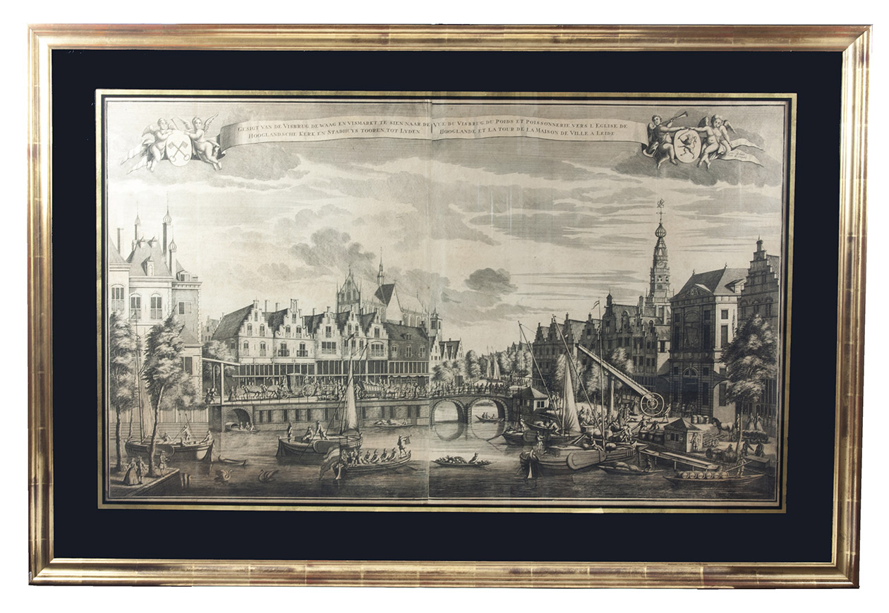 [VIEW - NETHERLANDS - LEIDEN]. SCHENK, Leonardus [and Abraham RADEMAKER]. - Gesigt van de Visbrug, de Waag en Vismarkt, te sien naar de Hooglandsche kerk en Stadhuys tooren, tot Lyden. | Ve du Visbrug, du Pois et Poissonerie, vers l'eglise de Hooglande et la tour de la Maison de Ville a Leide.[Amsterdam], Leonardus Schenk, [ca. 1728/35]. Large engraved wall print on 2 sheets, (together 58 x 97 cm) the sheets overlapping each other slightly, showing the traditional business centre of the city of Leiden. The title, both in Dutch and French, is printed in a banderole at the head, with putti on each side supporting the arms of Leiden and Holland. Leonardus Schenk's name appears as engraver and publisher at the right tip of the banderole. In black passepartout and gilt frame (82 x 121 cm).