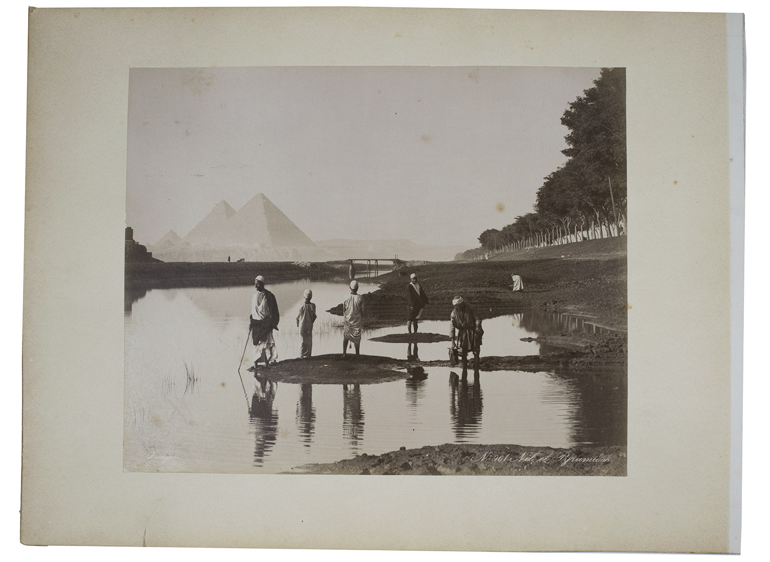 [EGYPT - PHOTOGRAPHY] ZANGAKI BROTHERS. - [Photographic prints of the Nile with pyramids in the background and of the Al-Azhar Mosque in Cairo]. No. 827 Cour de la Mosquee El-Azhar reunion des theologiens Caire; No. 901 Nil et Pyramides. [Egypt, Zangaki brothers, last quarter of the 19th century]. A single, oblong board (30 x 40 cm). 2 albumen photographic prints mounted on one board, 1 on each side (approx. 22,5 x 28 cm).