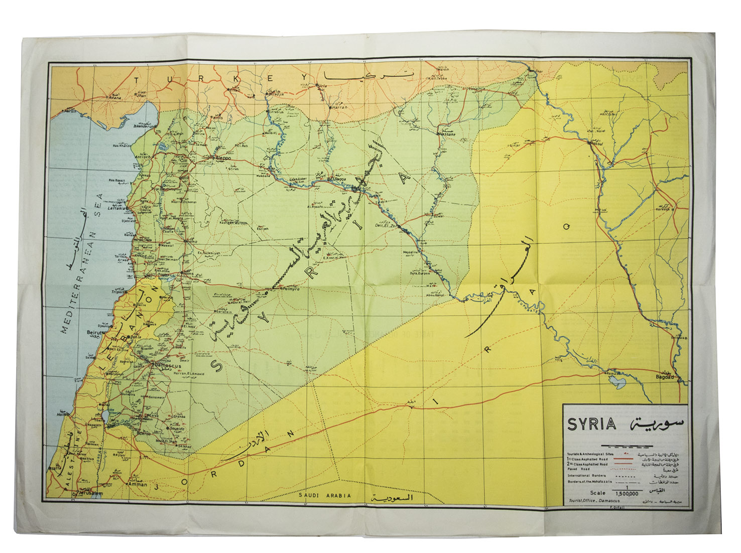 [SYRIA - BA'ATH ARAB SOCIALIST PARTY]. - Syria after two years of the March Revolution.[Syria, Ba'ath Arab Socialist Party], 1965. 24 x 17 cm. With 28 photos on 16 plates and some tables in the text. With: [MAP - SYRIAN ARAB REPUBLIC MINISTRY OF ECONOMY DIRECTORATE OF TOURISM]. Syria.Damascus, Tourist Office, [ca. 1965]. Folded. 70 x 49.5 cm.A brightly coloured folding map of Syria with some information about the country and its principal cities with a table of distances on the back, all text in the map and on the back is in English and Arabic.Original publisher's printed wrappers, stapled.