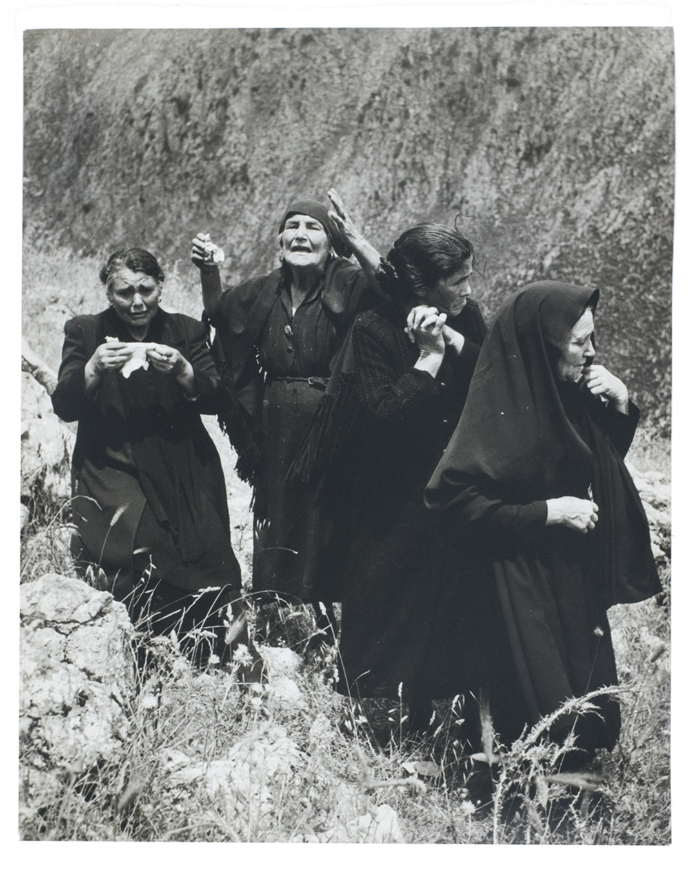 [PHOTOGRAPHS - MAFIA - SICILY]. SCAFIDI, Nicola. - [Photographs showing mob killings, grieving families and funerals].Palermo, [ca. 1961-1966?]. 5 loose silver gelatin photographic prints on baryta paper, ca. 24 x 30 cm, all but one with manuscript captions on the reverse.