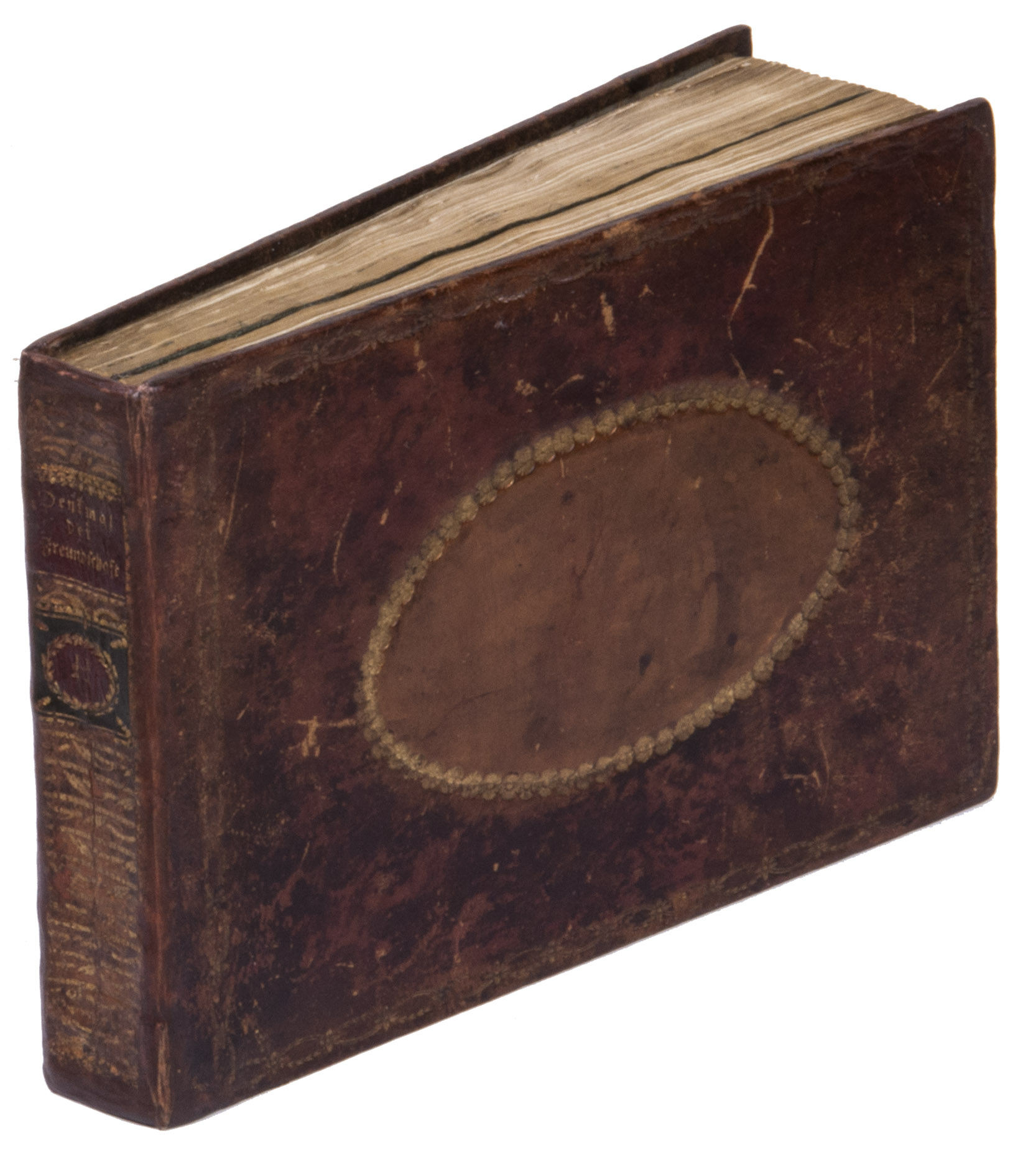 [ALBUM AMICORUM - HEINRICH, Carl Gottlieb]. - [Album amicorum of Carl Gottlieb Heinrich with entries written in Bischofswerda and surroundings, The Netherlands, France, Batavia in the Dutch East Indies, Bengal, and Reading, England].[Bischofswerda and surroundings, etc., 1802-1818]. 8vo oblong (12.8 x 18.2 cm). Richly illustrated with 13 watercolour drawings, some full-page, of tombs, a temple of friendship, vases, hunting scene, nice portraits, basket with fruit, etc., 2 views: washed drawings of Cape Town (folding) and Jamestown, St Helena, 2 drawings of children and an altar, 6 (stippled) engraved small plates pasted down of Amor, the military camp of Wallenstein, children and exotic people, and 3 embroideries. Contemporary gold-tooled marbled calf with a lighter brown leather oval inset as a centrepiece in both boards, gold-tooled spine with red and green morocco labels lettered in gold 