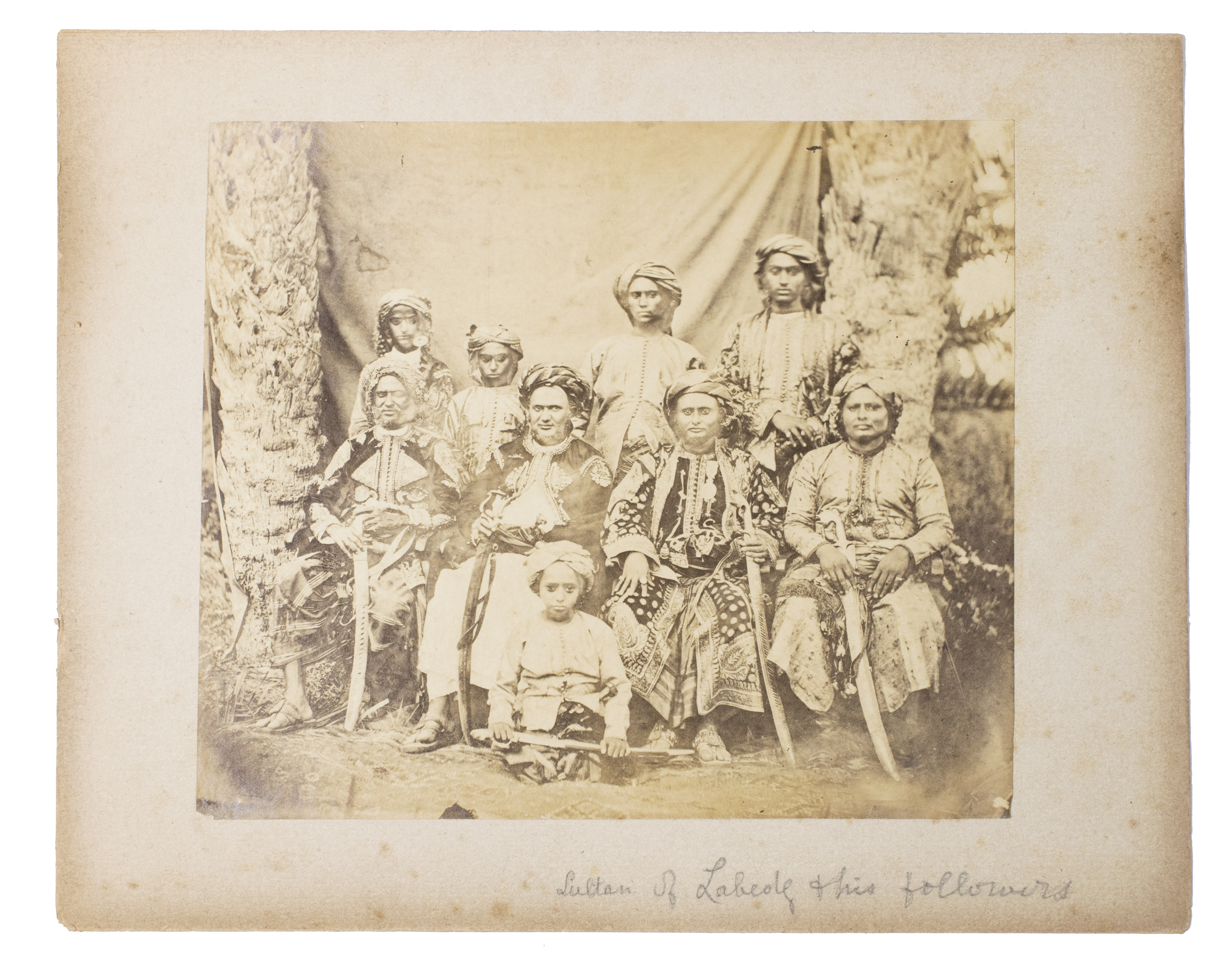 [PHOTOGRAPHY - SULTAN OF LAHEJ]. - [The Sultan of Lahej and his family].[Ca. 1877]. One albumen print (ca. 18 x 21 cm). Mounted onto a stiff paper mount (ca. 23 x 29 cm). Housed in a clear plastic sleeve.