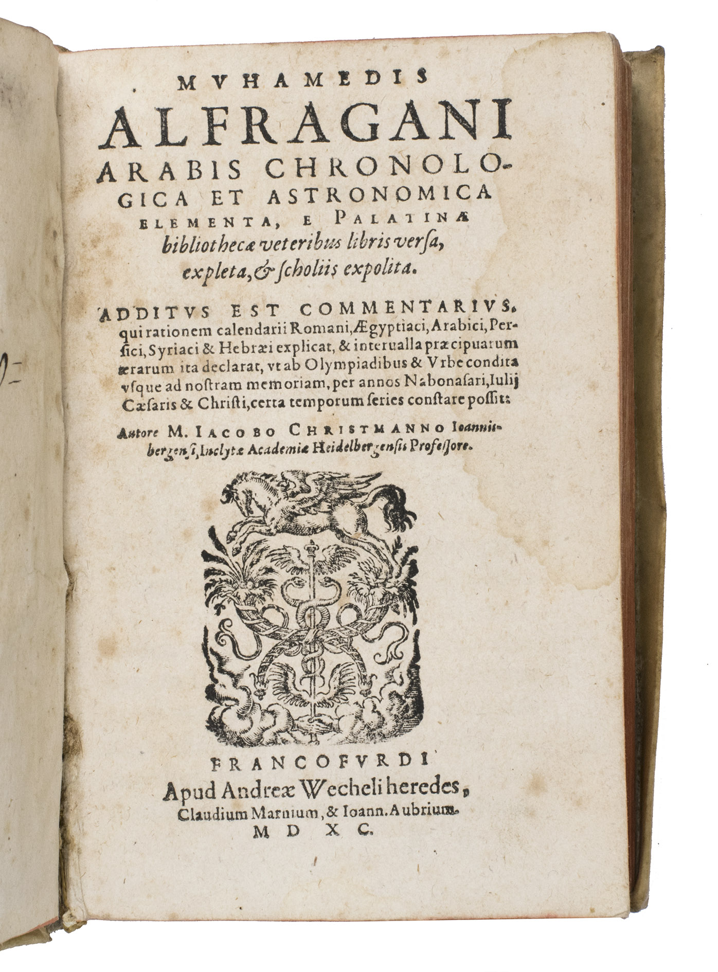 AL-FARGHANI, Ahmad ibn Mohammad ibn Kathir and Jacob CHRISTMANN (translator). - Chronologica et astronomica elementa, e Palatinae bibliothecae veteribus libris versa, expleta, & scholiis expolita.Frankfurt, Andreas Wechel (heirs of), Claude de Marne, and Johann Aubry, 1590. 8vo. With a woodcut vignette on the title page and the final leaf, a woodcut decorated initial, and a woodcut head- and tailpiece. Near contemporary overlapping vellum with the manuscript title on the spine, remnants of ties, red edges.