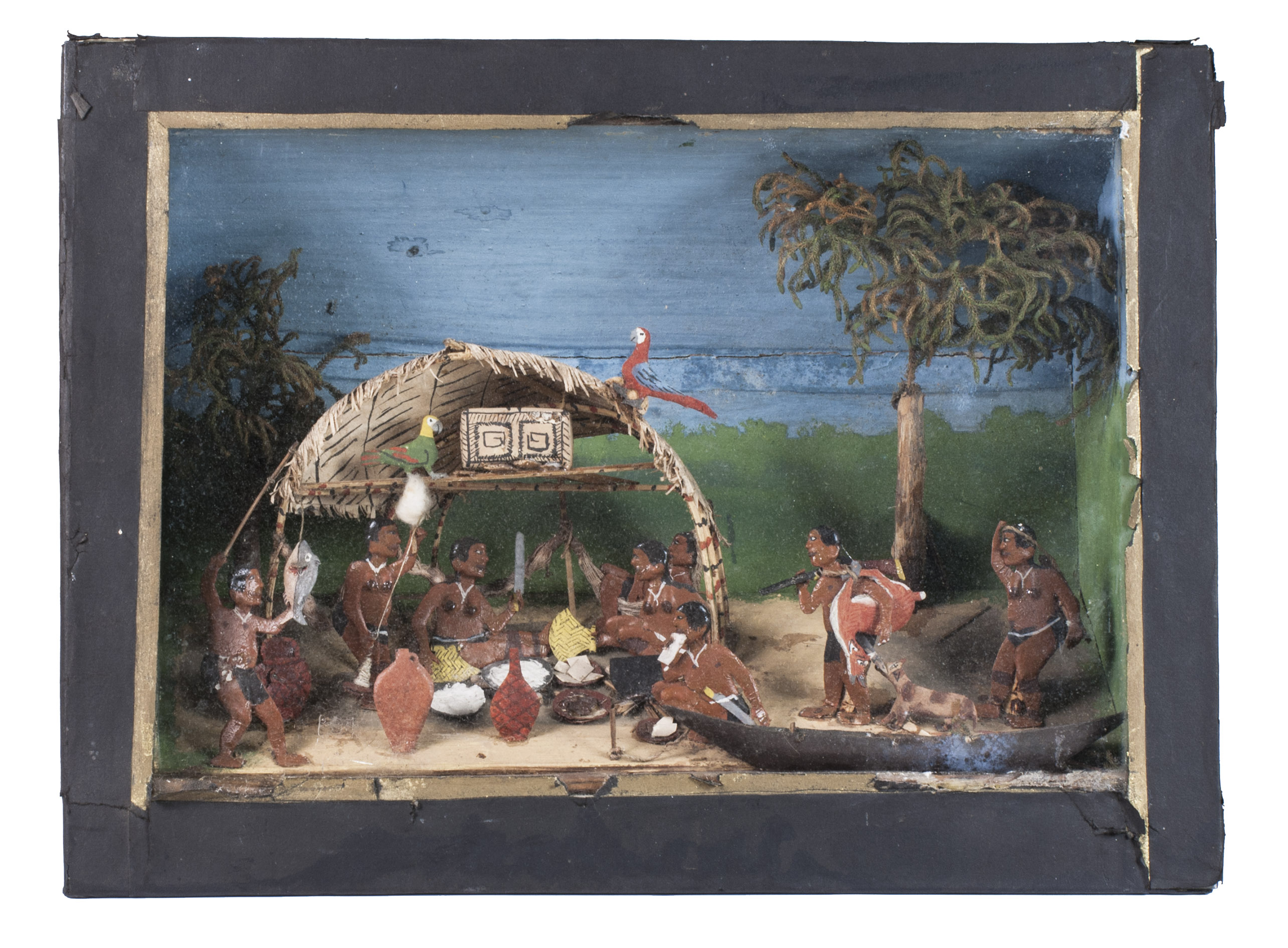 [DIORAMA - SURINAME]. - [An indigenous community in Suriname].[19th century]. 28.5 x 38.5 x 11.5 cm. A diorama made with papier-mch, wood, dried plant material, and oil paint. The wooden outside has been covered in black paper. The diorama can be viewed through a glass plate.