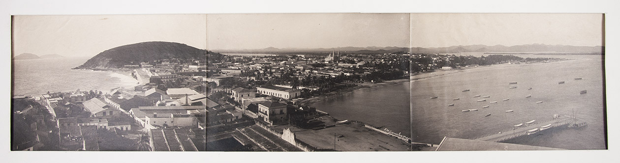 [PHOTOGRAPHY - MEXICO]. GONZALEZ, F.M. - [Panoramic photograph overlooking Mazatln].[Mexico, ca. 1880-1900]. Albumen print (ca. 17 x 71 cm) in 3 parts with photographer's credit in white in the negative, mat mount. Pasted on heavily spotted and browned contemporary wove paper.