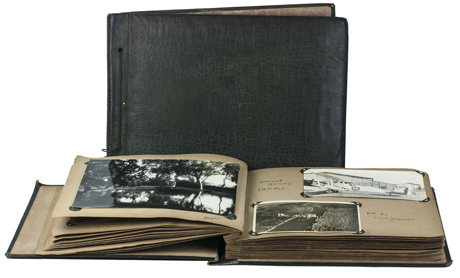 [PHOTOGRAPHS - IRAQ]. REYNISH, William. - [Views, scenes, monuments, airplanes, military vehicles, British troops and local inhabitants].[Iraq (plus Malta and Egypt), ca. 1928-1933]. Oblong albums (25 x 34.5 cm & 21.5 x 28.5 cm). Two albums containing about 275 silver halide photographic gelatin prints (6 x 8.5 cm to 16 x 21.5 cm) assembled and mostly taken by a British Royal Air Force pilot while stationed in Iraq and then briefly Malta, with a visit to Egypt. The photos mounted with paper corner-mounts in two contemporary cloth-covered albums, the larger with padded boards covered in alligator-skin patterned dark green cloth, with the photographs on both sides of 24 dark grey album leaves, each leaf with a glassine paper guard-leaf (embossed with a spider-web pattern) bound in before it; the smaller covered in black cloth with a grey-white bird in a cloud painted on the front board and the word snaps, with the photographs on both sides of leaves 2-35 & 51-52 of 54 light brown album leaves.