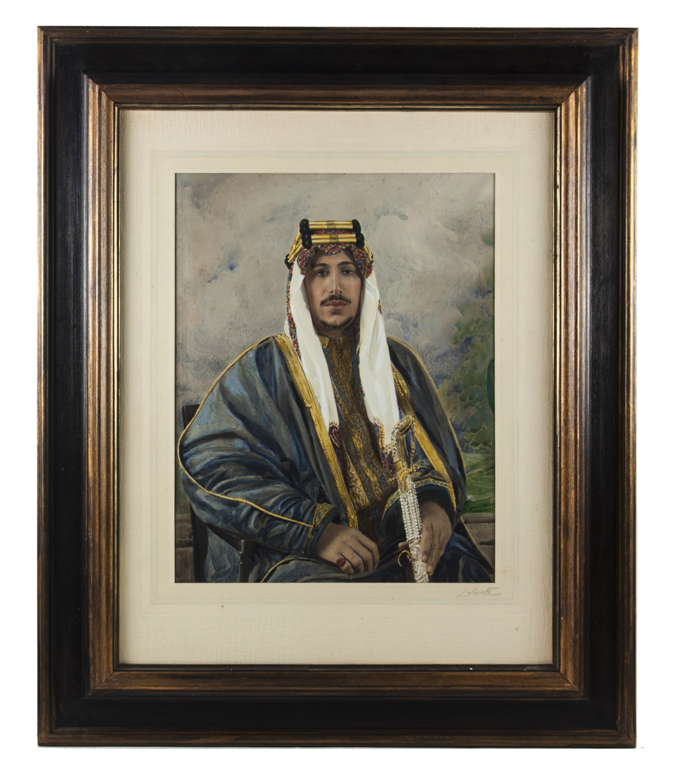[PHOTOGRAPH - HAND COLOURED]. LAFAYETTE STUDIO. - [Crown Prince Saud bin Abdulaziz Al Saud of Saudi Arabia].[London, 1935]. Matt silver print (ca. 28 x 36 cm), watercolour, pastel, gouache and oil paint. Mounted on paper in a passe-partout. Signed 