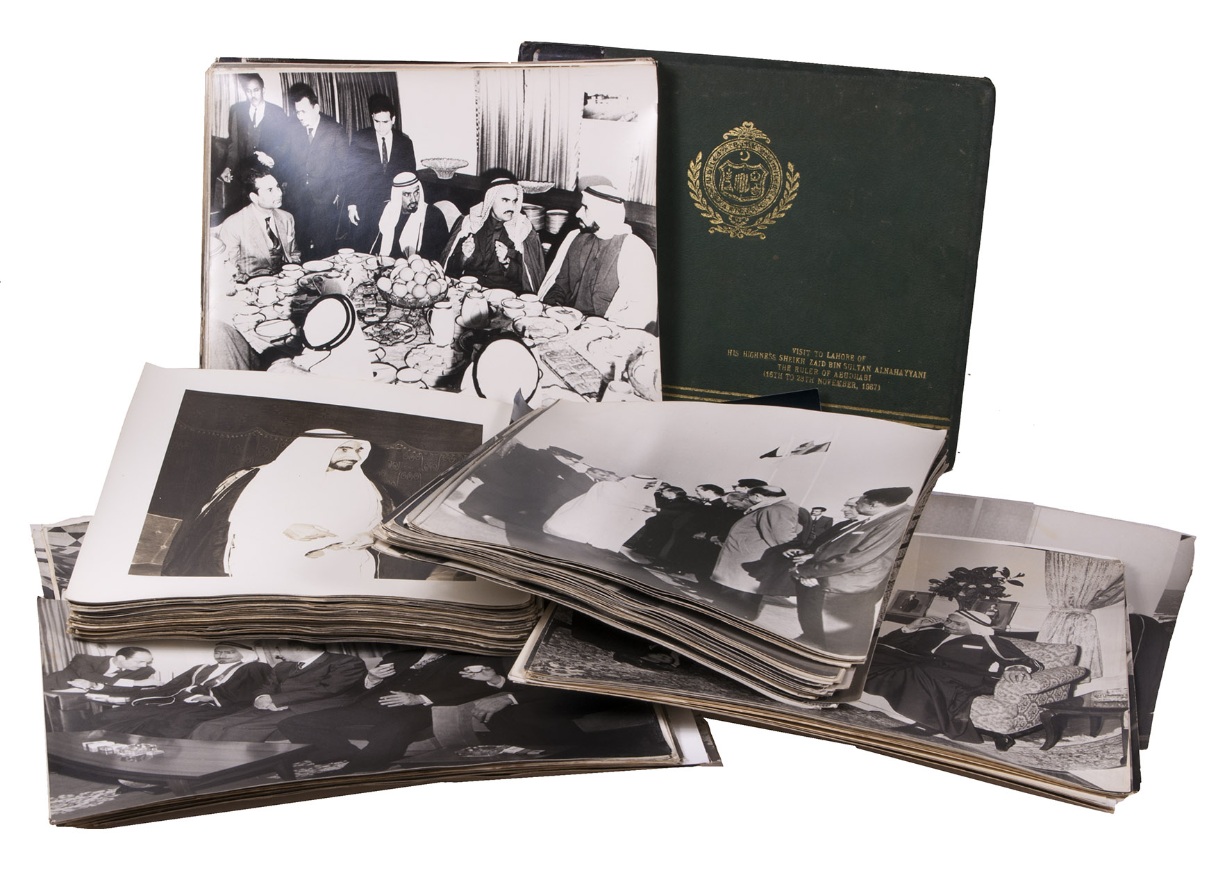 [ABU DHABI  STATE VISITS TO PAKISTAN]. - [Photograph archive and album. Album title]: Visit to Lahore of His Highness Skeikh Zayed bin Sultan Alnahayyani the ruler of Abudhabi (16th to 28th November, 1967).[Pakistan, 1967-1971]. An archive of 183 photographs: 133 loose black and white photographic prints (ca. 30 x 25 cm), 30 smaller ones (ca. 5 x 6 cm) numbered and mounted together on a single sheet of paper, and 20 additional prints in the album. Further with numerous rolls of original medium format negatives.Original black half morocco album, green cloth sides with title and emblem of the United Bank Limited Pakistan on the front board.
